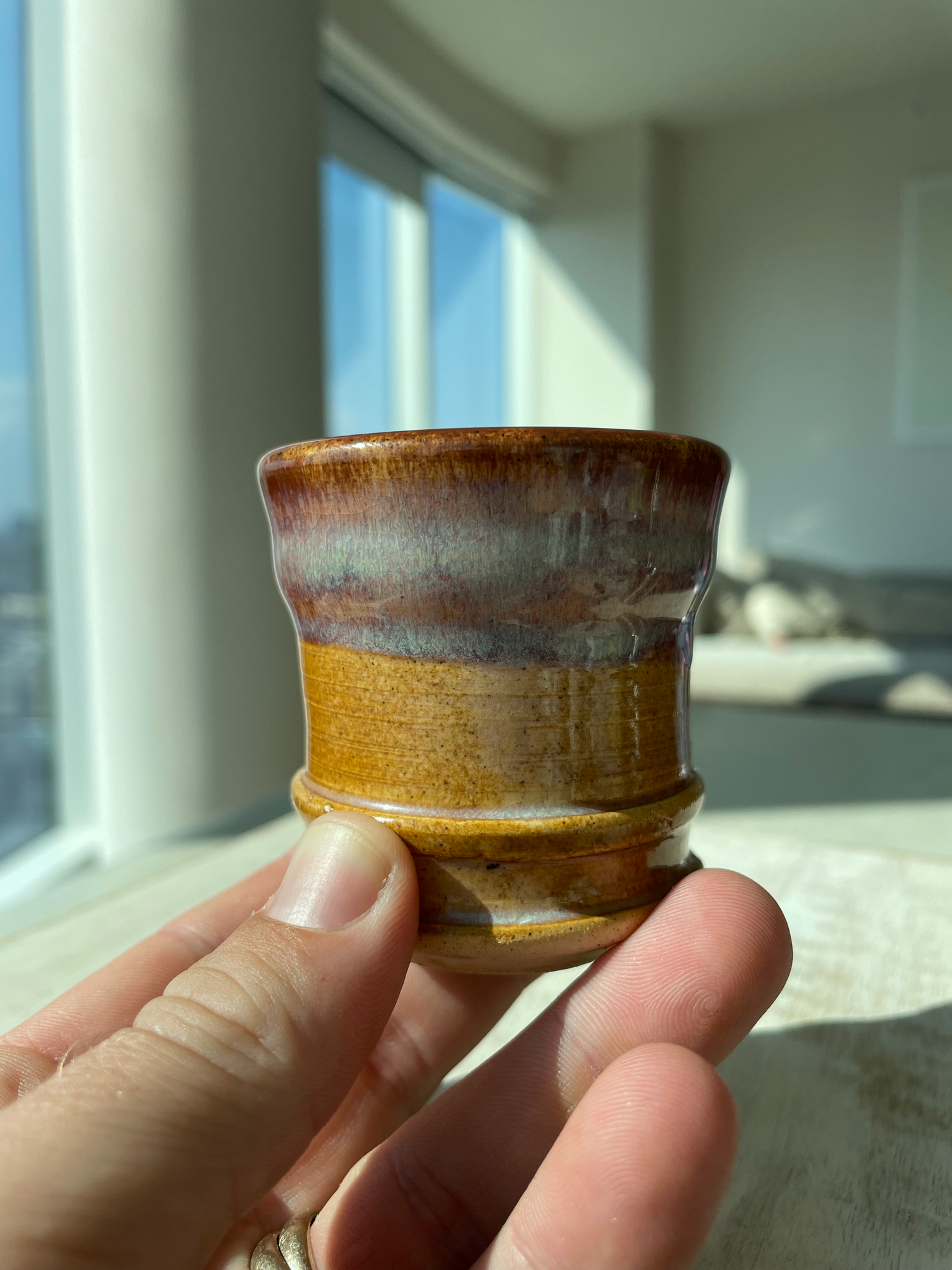brown espresso cup being held